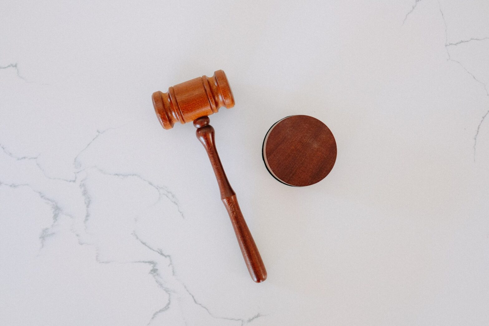 Gavel sitting on a marble desk.