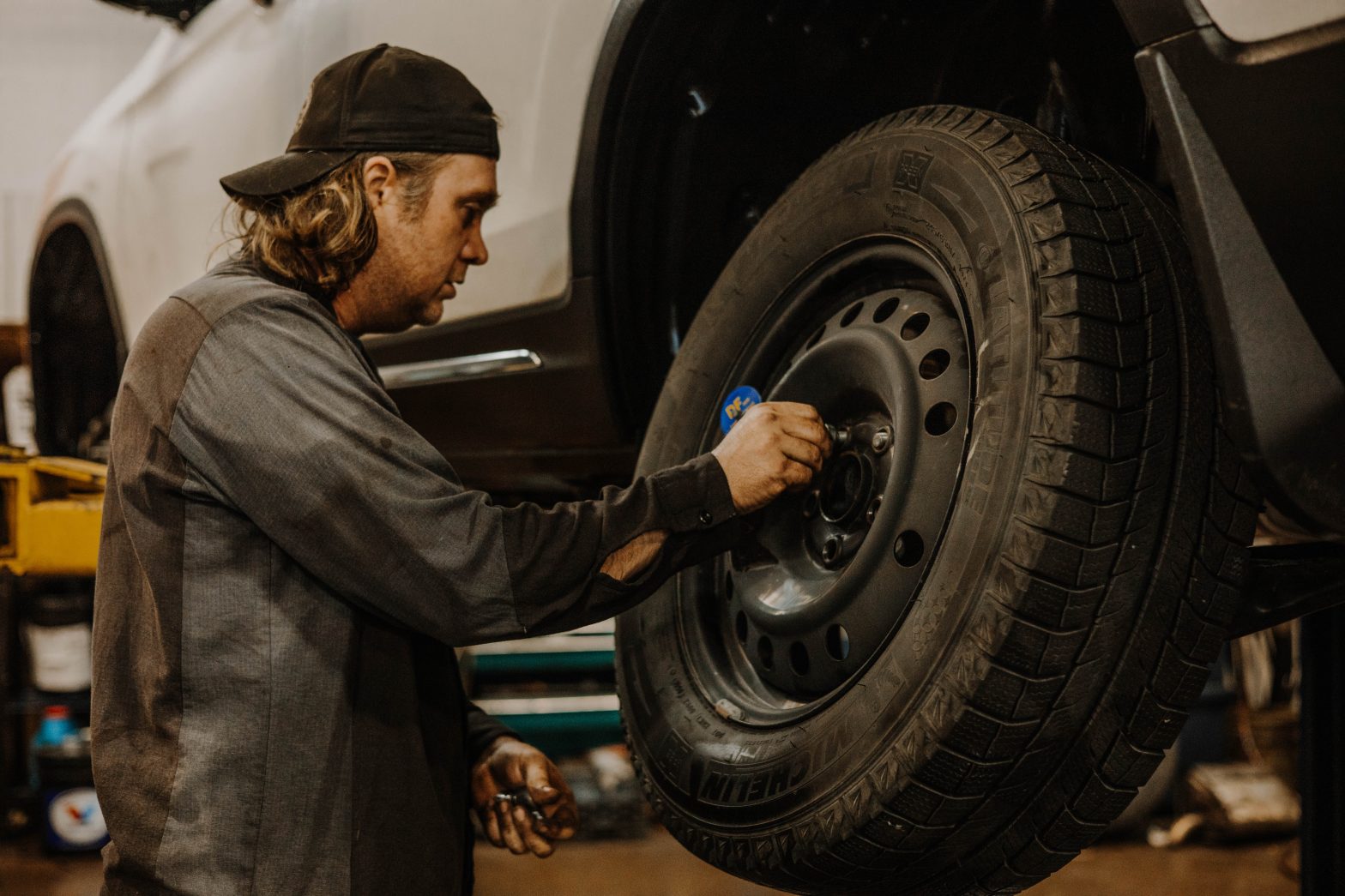 Friendly team members assisting clients with winter tire changes.