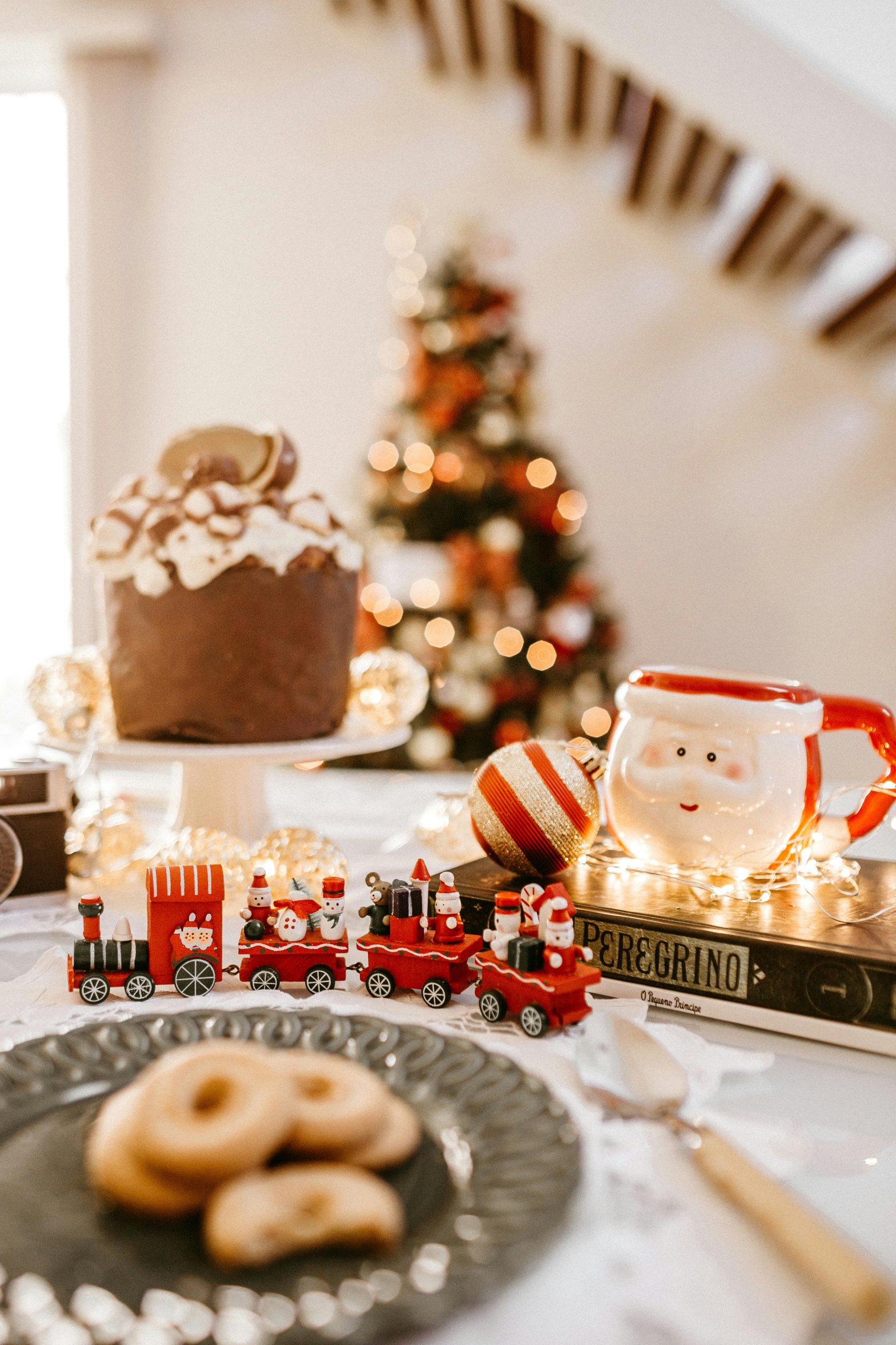 Christmas train and Santa Claus mug on a festive table