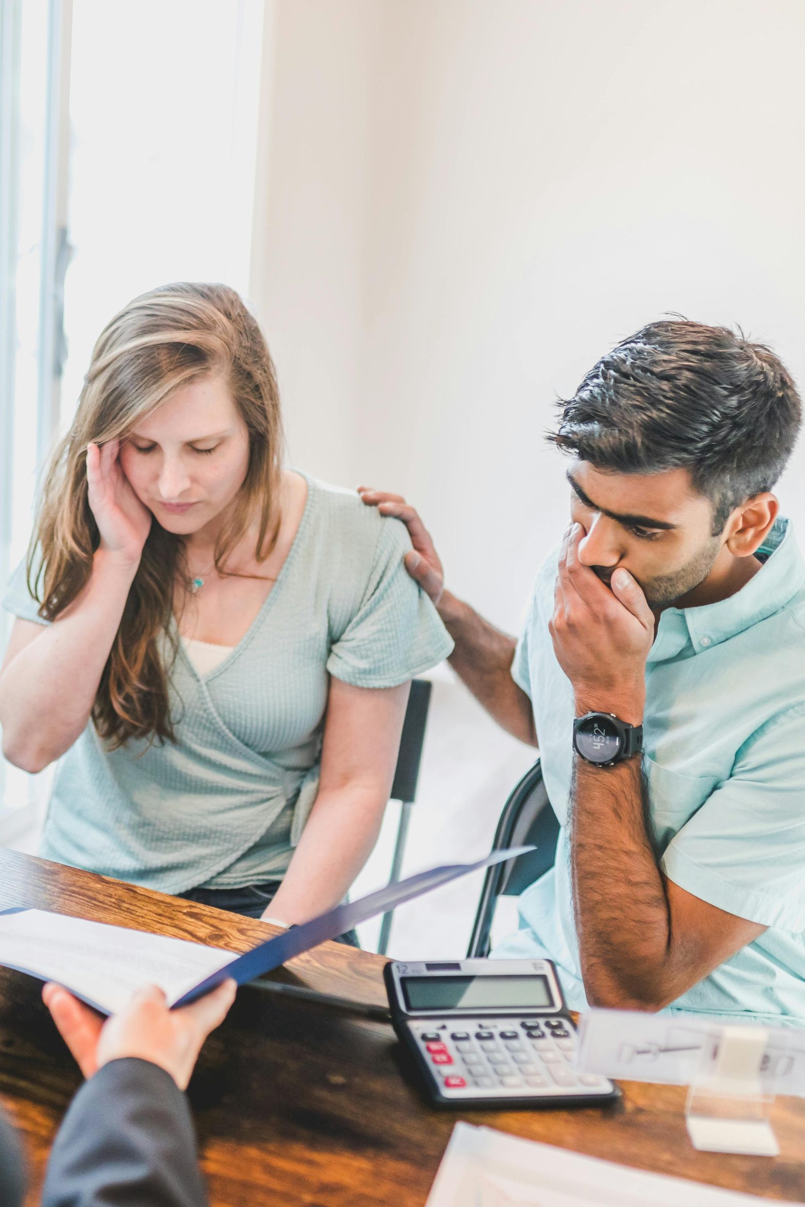 A real estate agent discussing a home purchase with a couple.